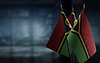 Pequeñas banderas de Vanuatu sobre un fondo borroso abstracto | Foto de stock