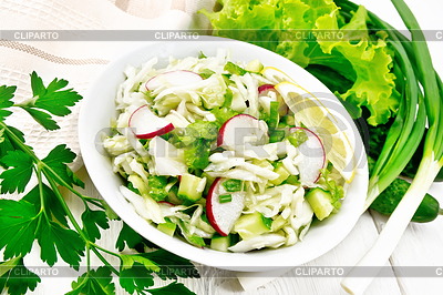 Salad of cabbage with radish in plate on light board | High resolution stock photo |ID 7347832