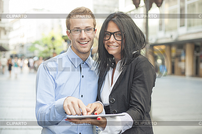 Two businesspeople on street with tablet computer | High resolution stock photo |ID 3497966