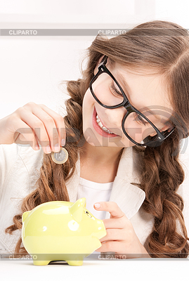 Little girl with piggy bank and coin | High resolution stock photo |ID 3613738