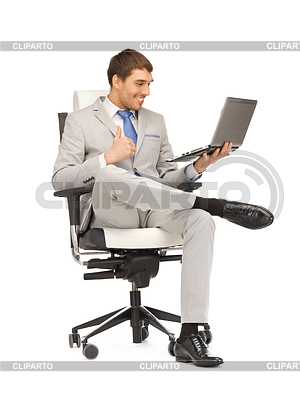 Young businessman sitting in chair with laptop | High resolution stock photo |ID 3644739