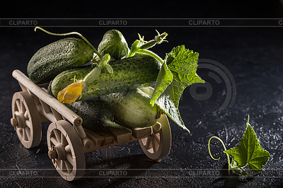 Green fresh cucumbers on dark stone background | High resolution stock photo |ID 6640328